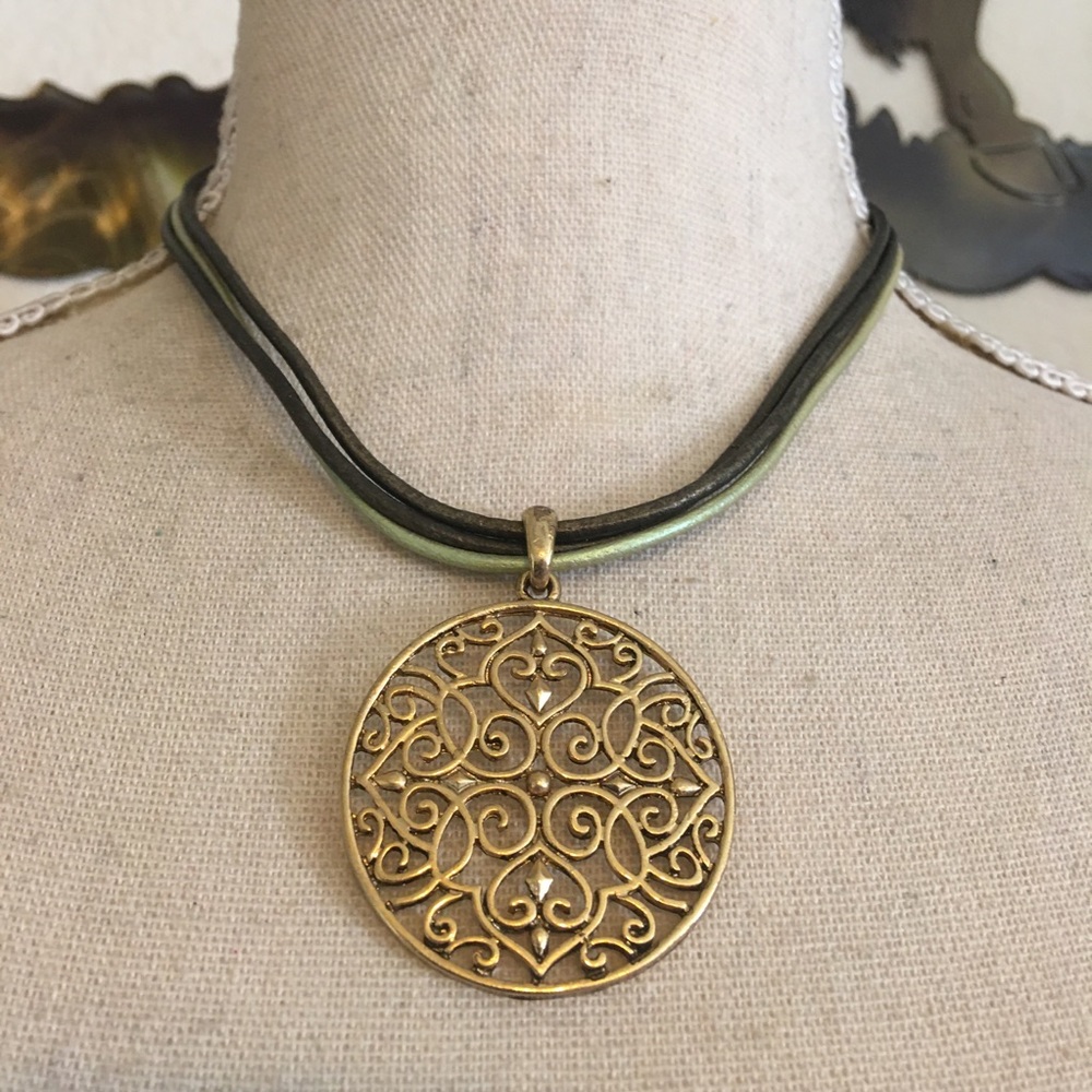 Gold tone filigree medallion cord necklace